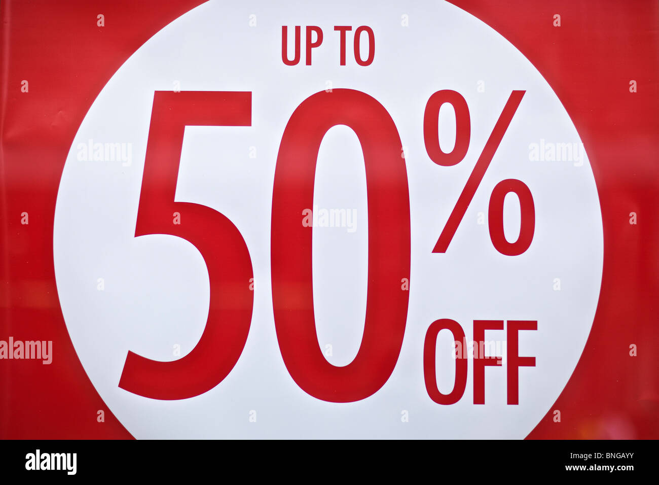 Up to 50%off sale poster in shop window on High Street Stock Photo