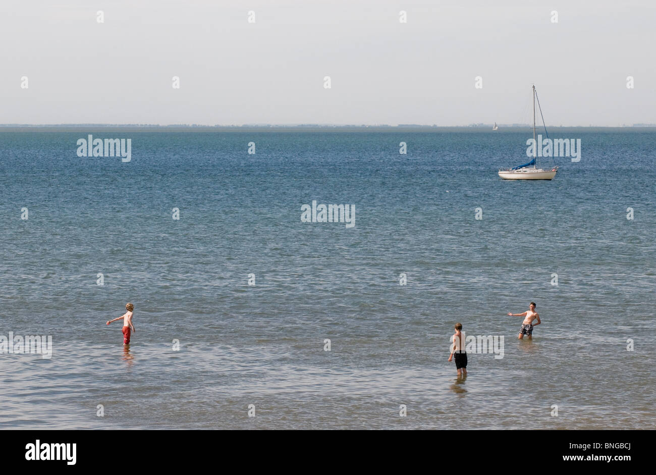 Three young boys paddling in the sea at Whitstable in Kent.  Photo by Gordon Scammell Stock Photo