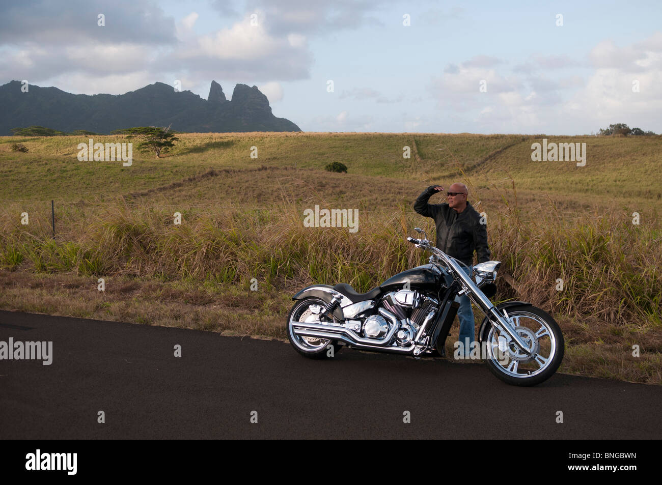 Hawaiian man posing by road motorcycle, Kauai, Hawaii Stock Photo - Alamy