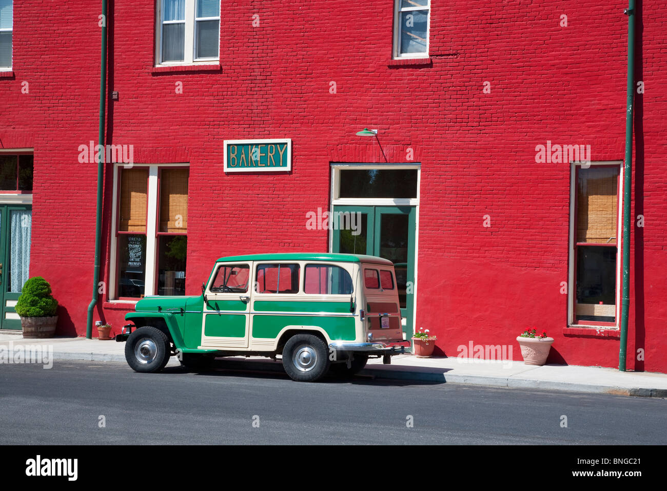 Antique Willy's parked in front of red buiding. Palouse, Washington. Stock Photo