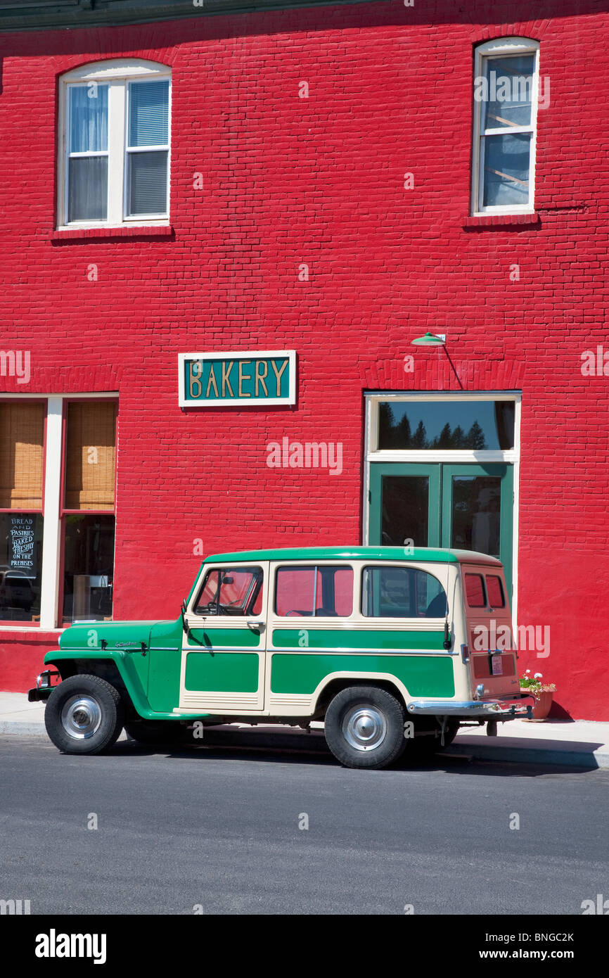 Antique Willy's parked in front of red buiding. Palouse, Washington. Stock Photo
