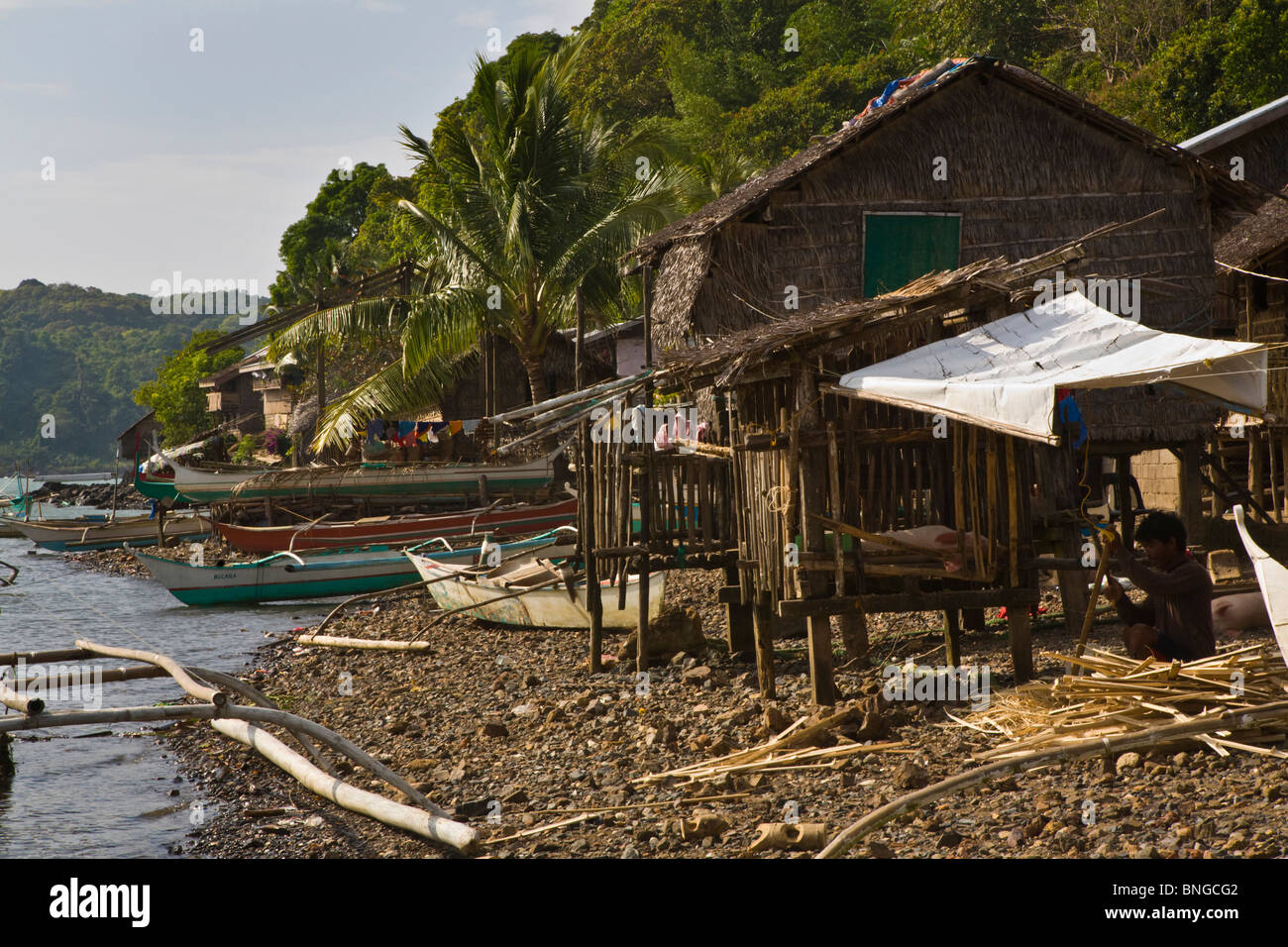 Catamarans And Houses In A Small Fishing Village North Of El Nido