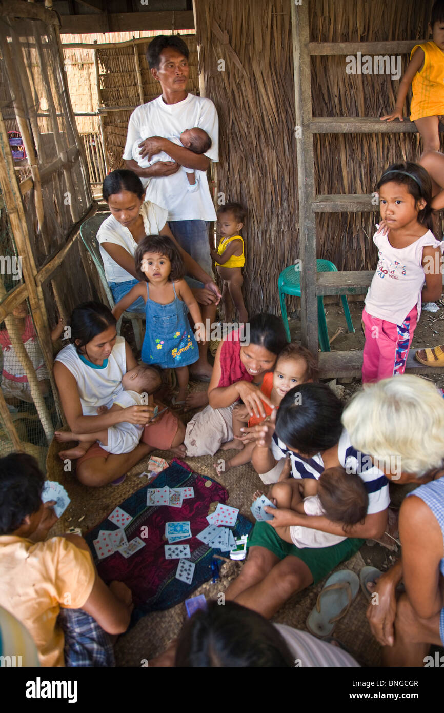Filipinos play cards in a small fishing village north of EL NIDO - PALAWAN ISLAND, PHILIPPINES Stock Photo