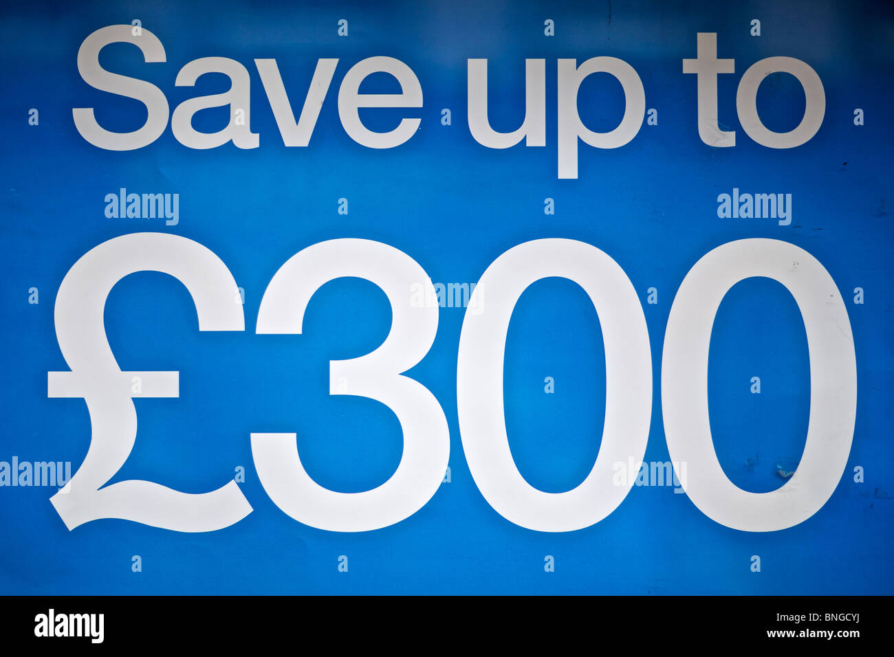 Save up to £300 poster in shop window on High Street Stock Photo