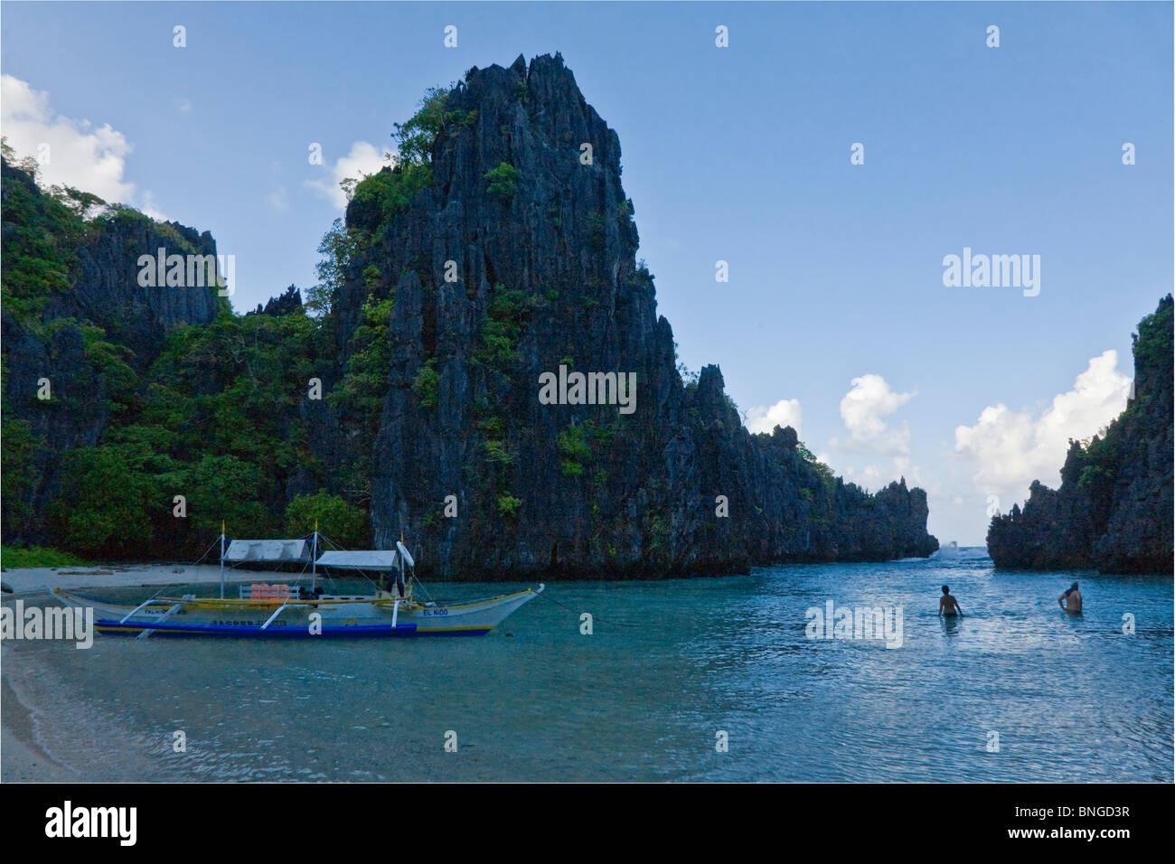 Our boat at a secluded beach on MATINLOC ISLAND near EL NIDO in the BACUIT ARCHIPELAGO - PALAWAN ISLAND, PHILIPPINES Stock Photo