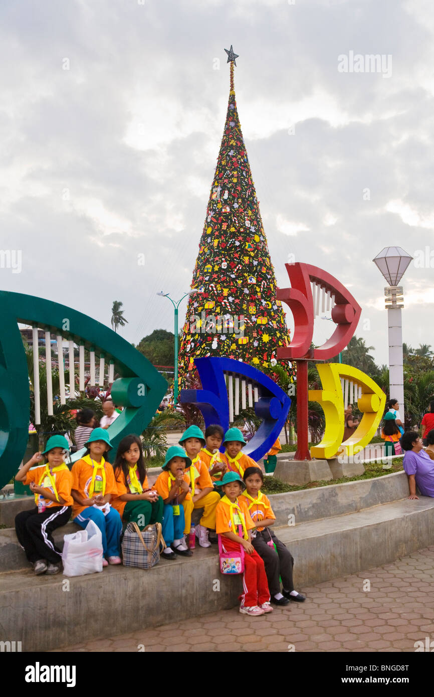A CHRISTMAS TREE and SCHOOL CHILDREN in PUERTO PRINCESS on PALAWAN ISLAND - PHILIPPINES Stock Photo
