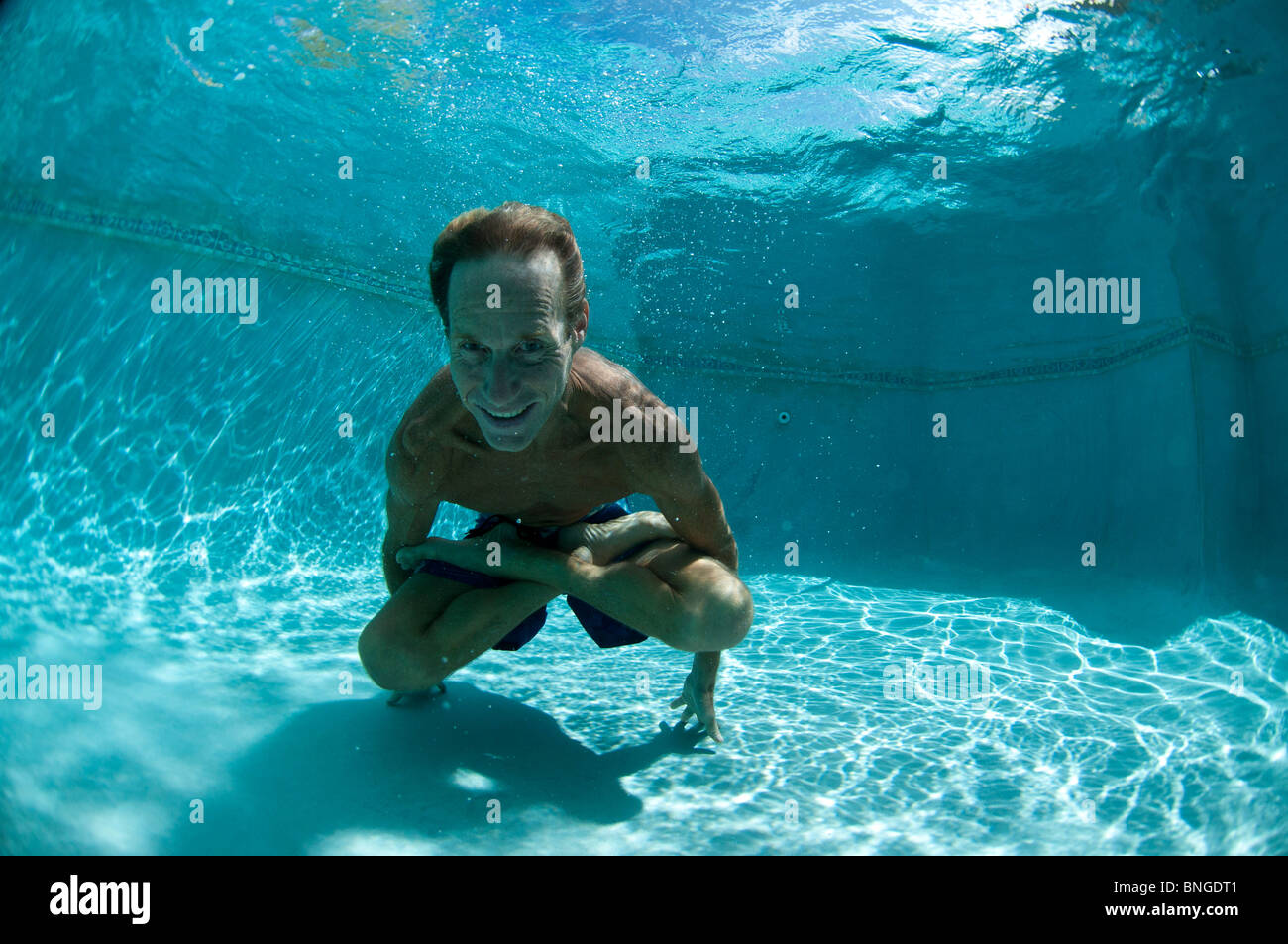 https://c8.alamy.com/comp/BNGDT1/man-doing-yoga-underwater-in-pool-kauai-hawaii-BNGDT1.jpg