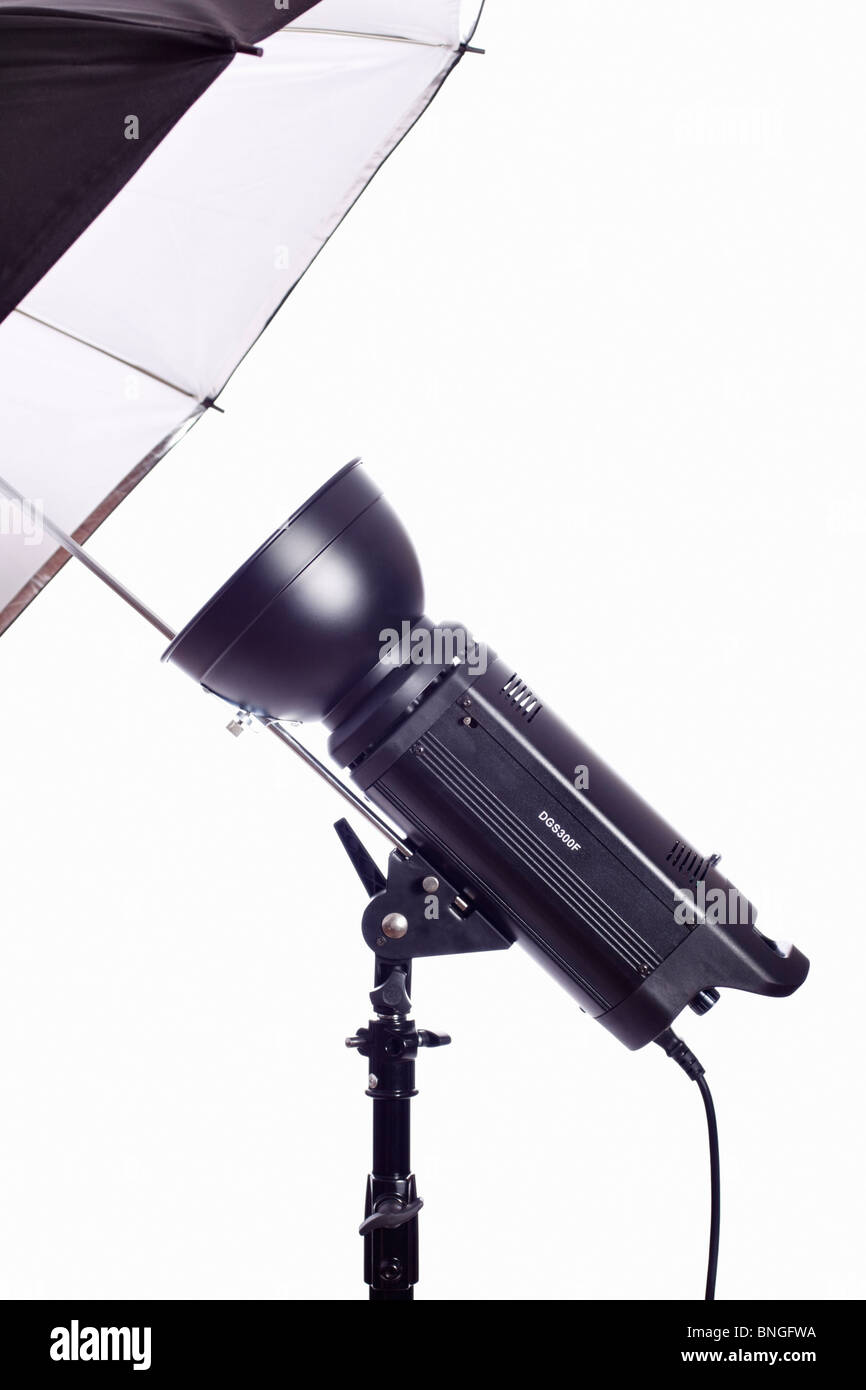 Monolight on stand with reflective umbrella used for photographic studio lighting. Isolated. Stock Photo