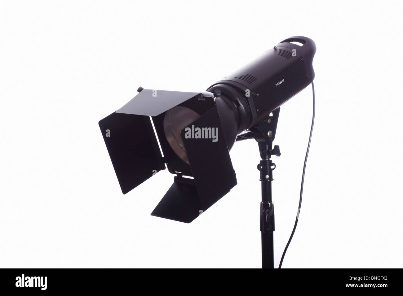 Monolight on stand with barn doors used for photographic studio lighting. Isolated. Stock Photo