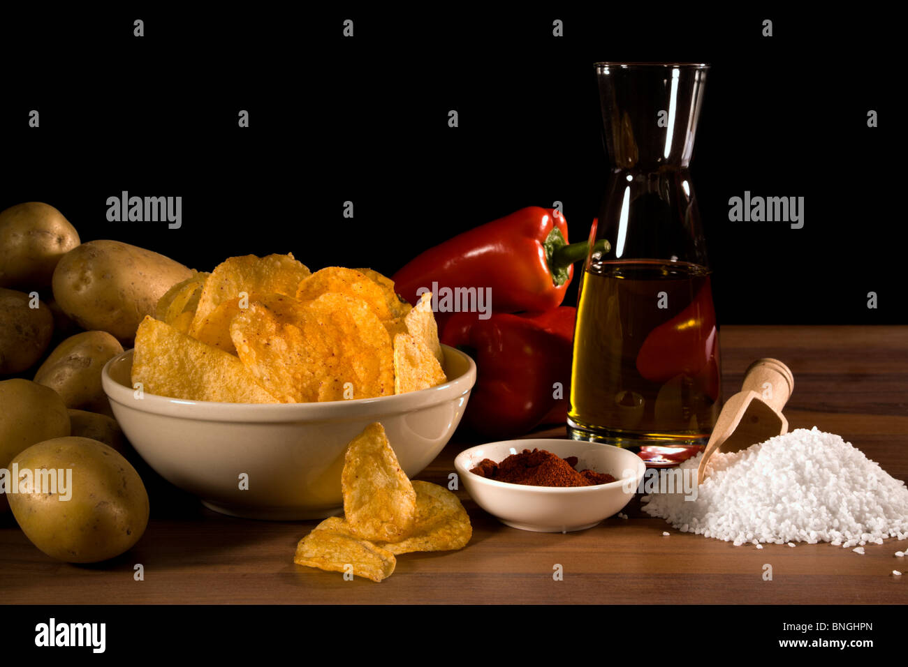 still life with potato chips and their ingredients potatoes, red