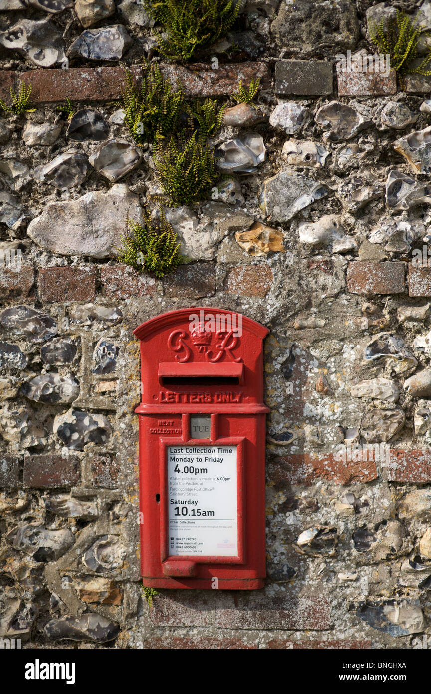 A traditional English flint and brick wall with its in-built post box. Stock Photo