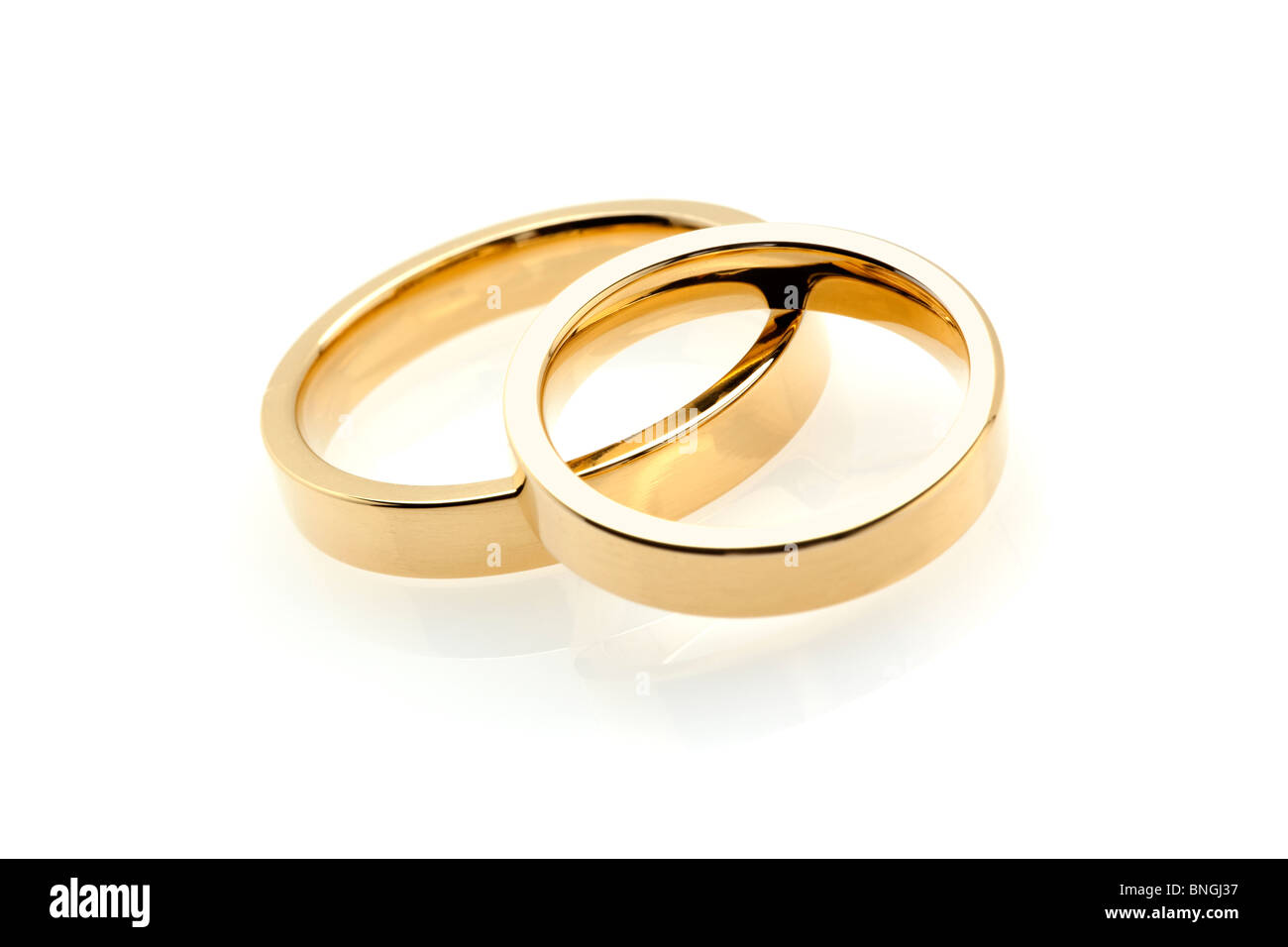 pair of golden wedding rings on white background Stock Photo Alamy