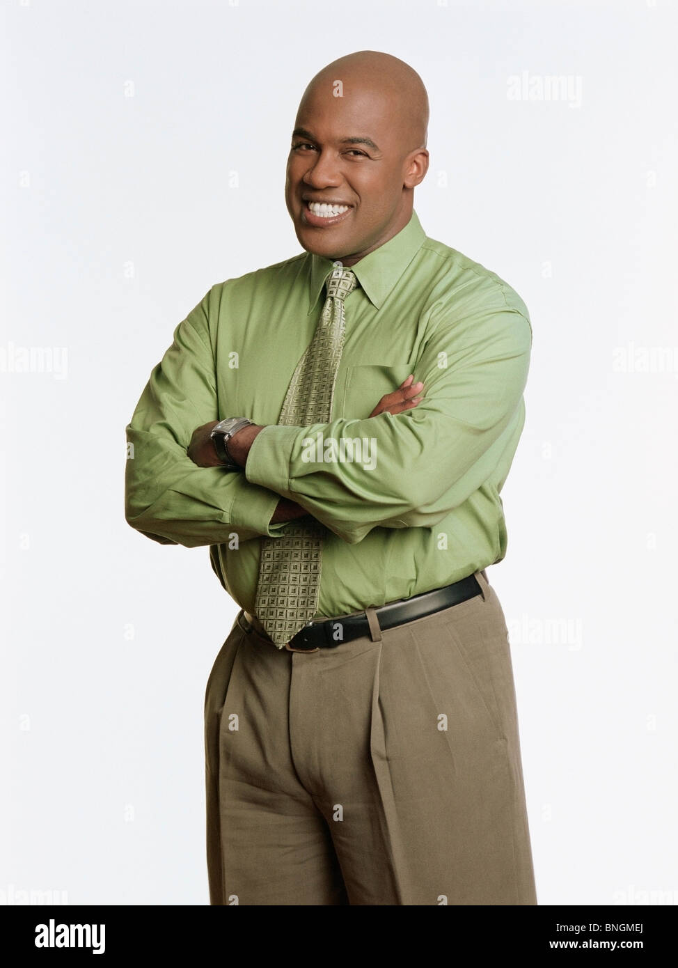 Businessman standing with his arms crossed and smiling Stock Photo - Alamy