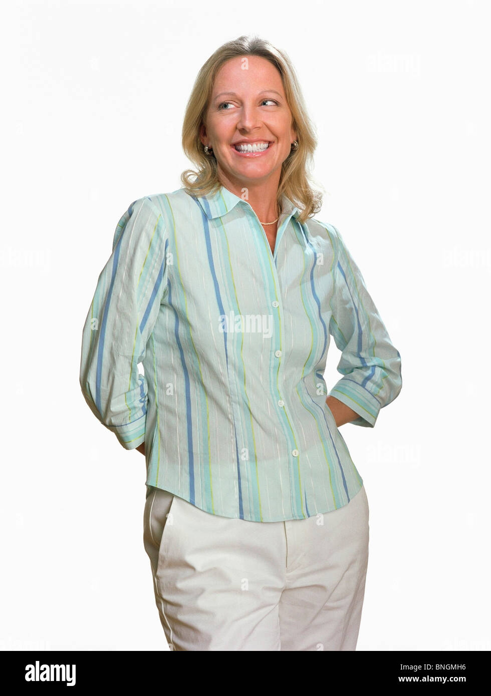Woman standing with her hands behind her back Stock Photo - Alamy