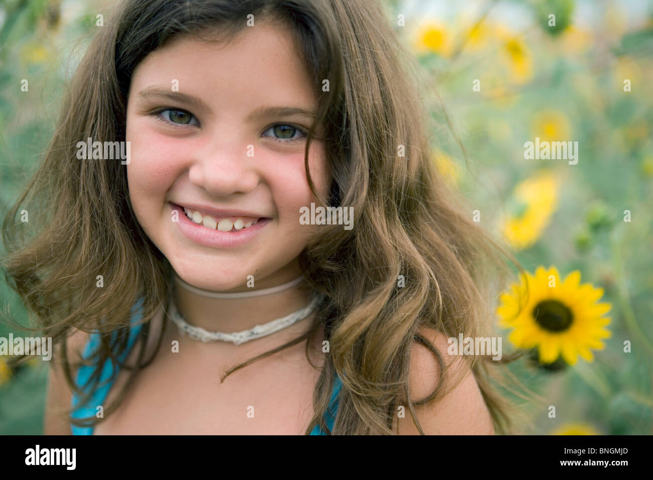Portrait of a girl smiling in the field of sunflowers Stock Photo - Alamy