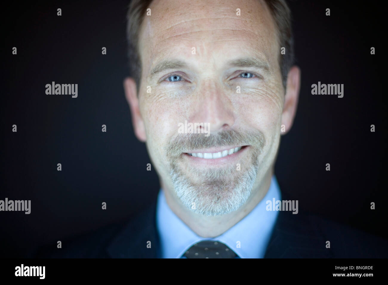 Portret of businessman smiling at camera Stock Photo - Alamy