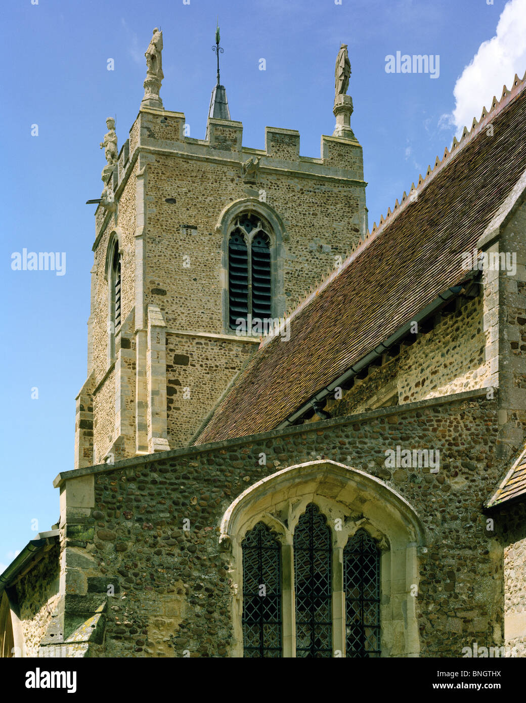 Figures on tower St Margaret's Church Abbotsley village Cambridgeshire