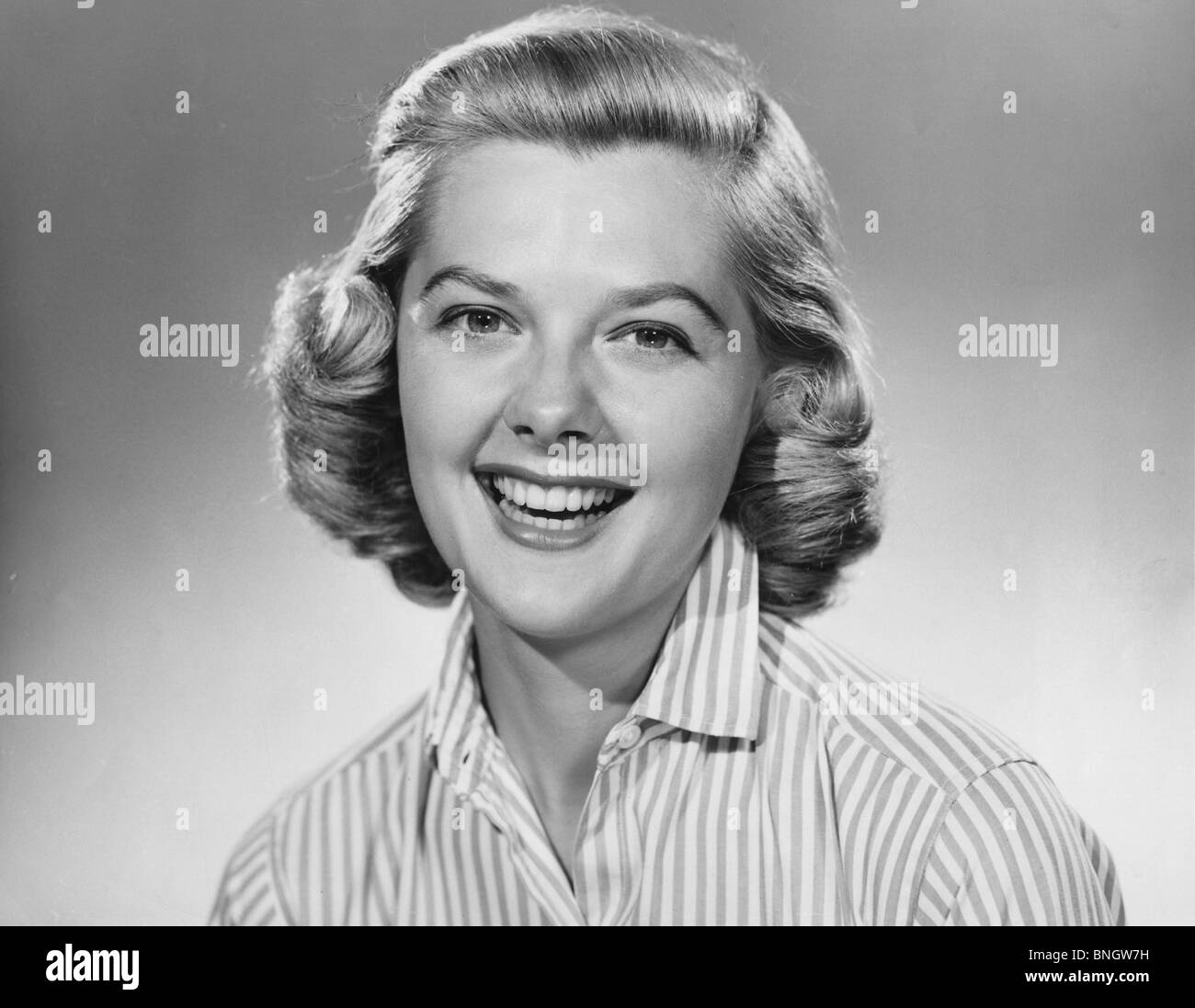 Studio portrait of young woman smiling Stock Photo
