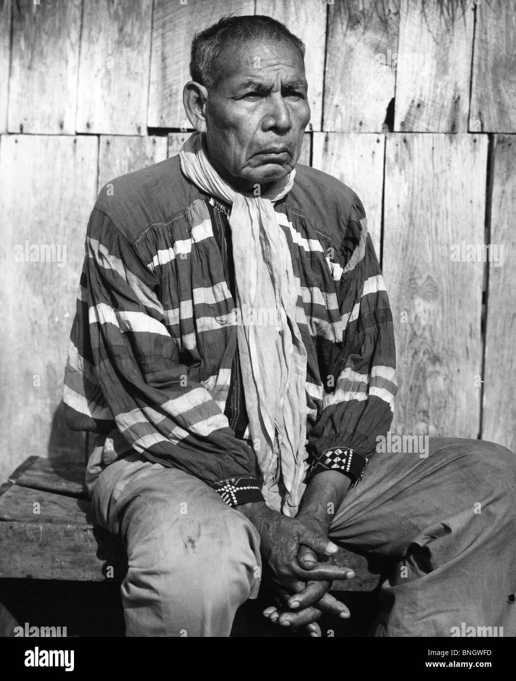 Seminole man sitting with his hands clasped, 1970s Stock Photo