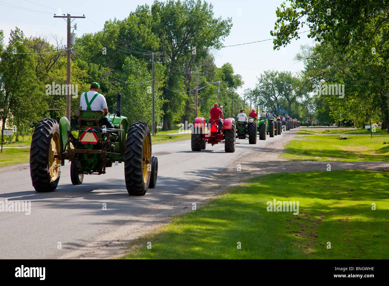 A procession of antique tractors at the 2010 Tractor Trek in Reinland, Manitoba, Canada. Stock Photo