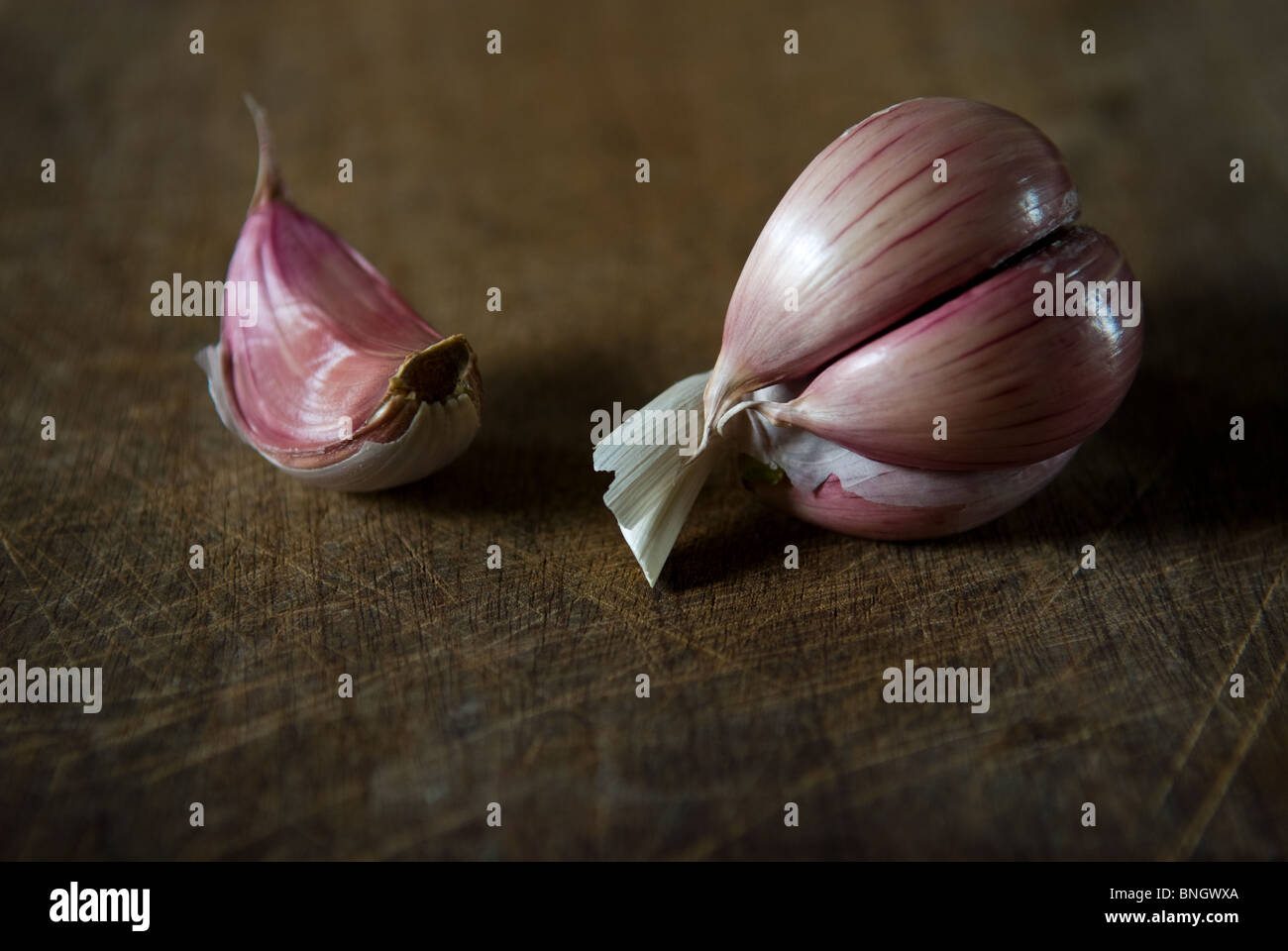 Cloves of garlic on a wooden board Stock Photo