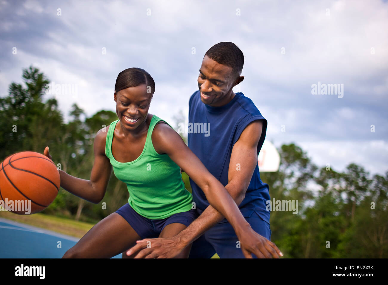 Young couple playing basketball Stock Photo - Alamy