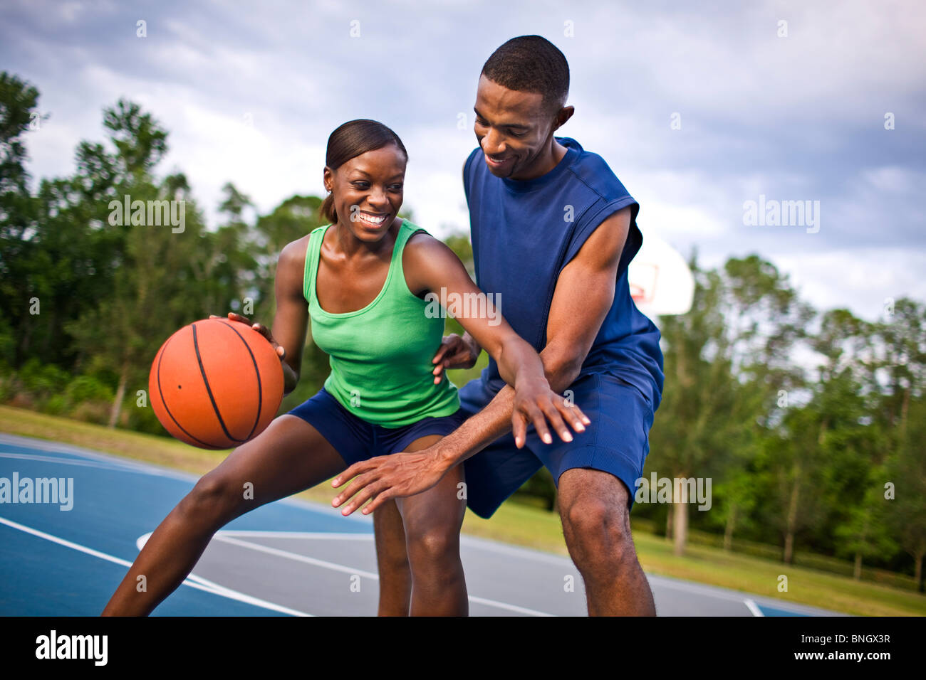 Young couple playing basketball Stock Photo - Alamy