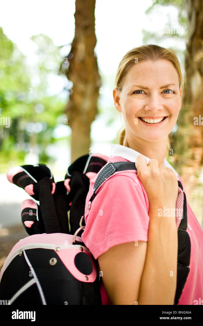 Mid adult woman carrying a golf bag Stock Photo Alamy