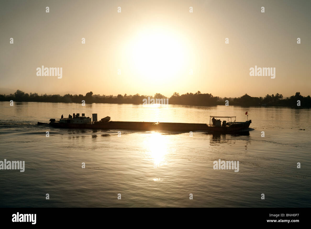 Nile sunrise; Sunrise over a barge on the river Nile, Egypt Africa Stock Photo