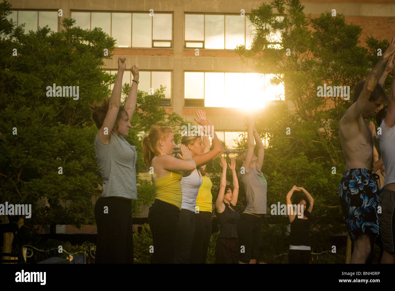 Yoga practitioners participate in a free yoga class in the New York neighborhood of Chelsea Stock Photo