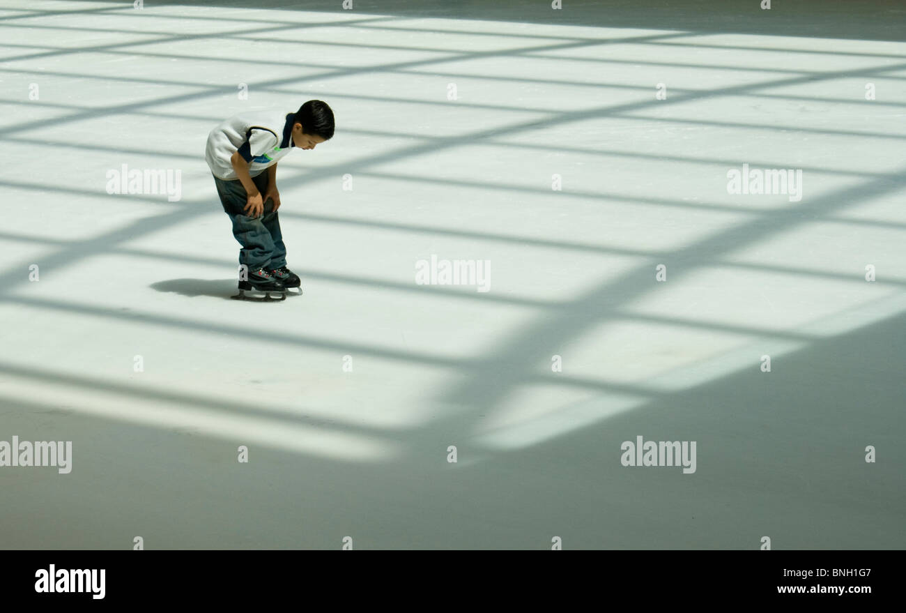 Young male ice skater at the Galeria ice rink in Houston Texas Stock