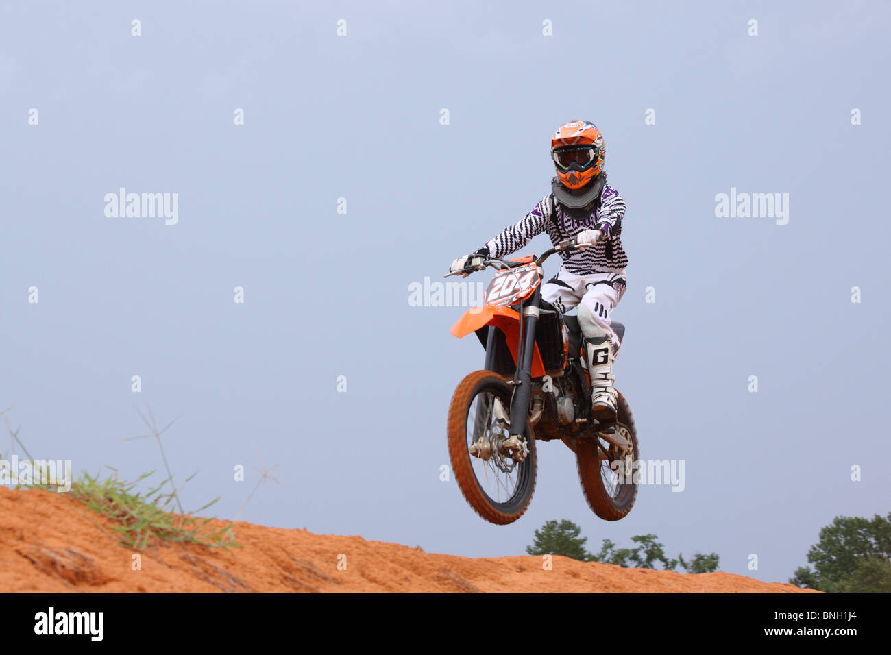 motorcycle rider on a dirt bike running a motocross track Stock Photo ...