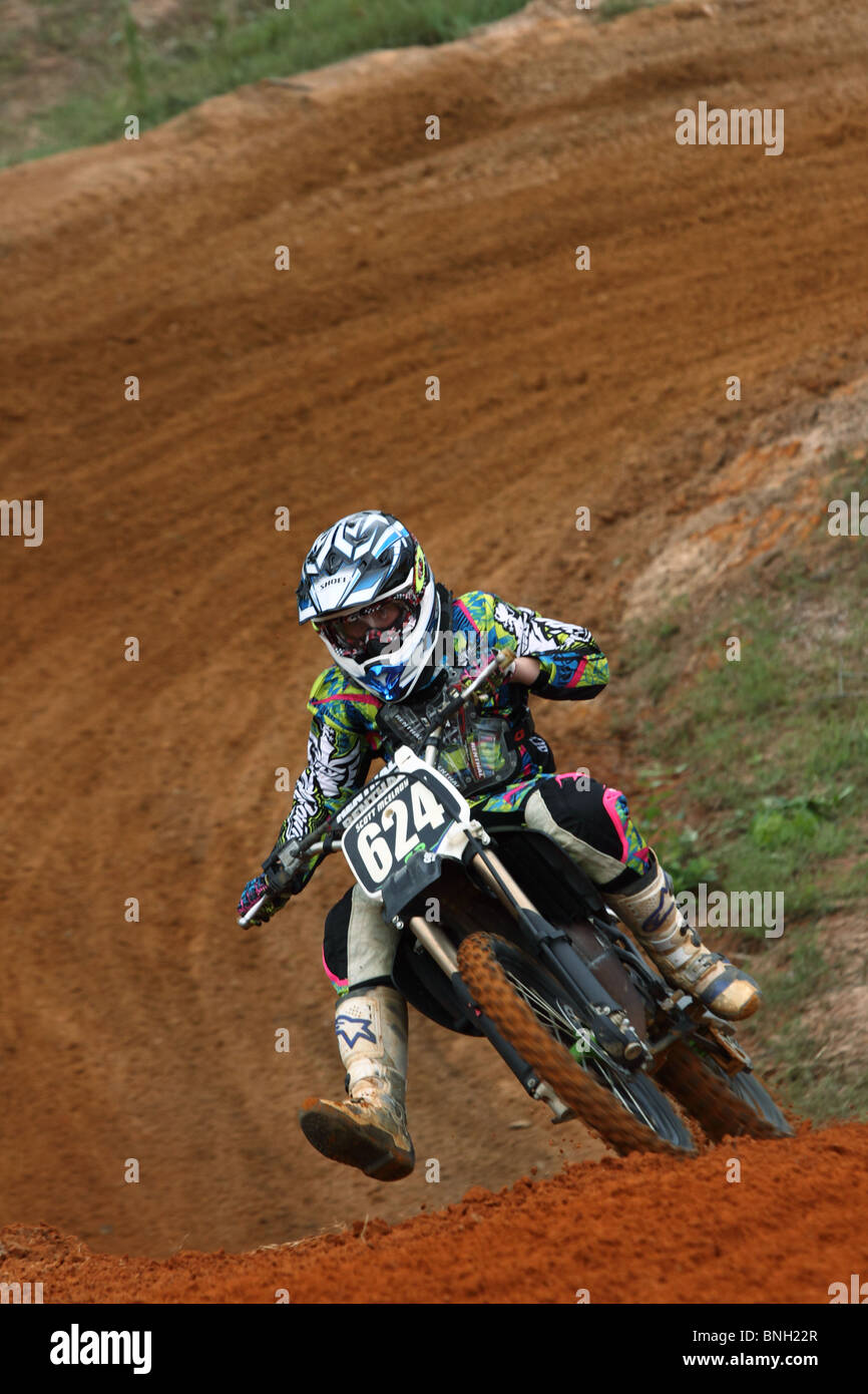 motorcycle rider on a dirt bike running a motocross track Stock Photo