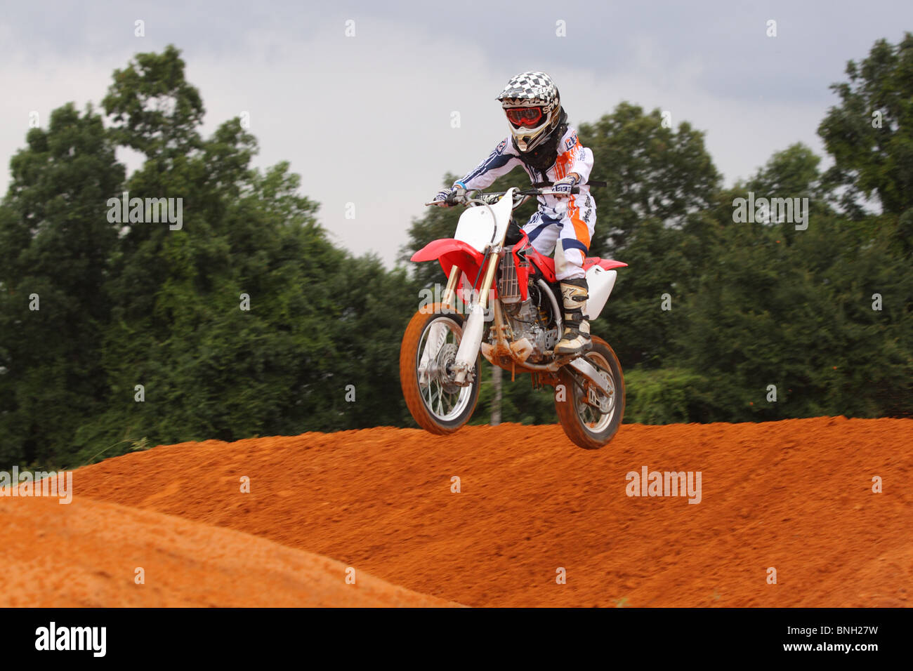 motorcycle rider on a dirt bike running a motocross track Stock Photo
