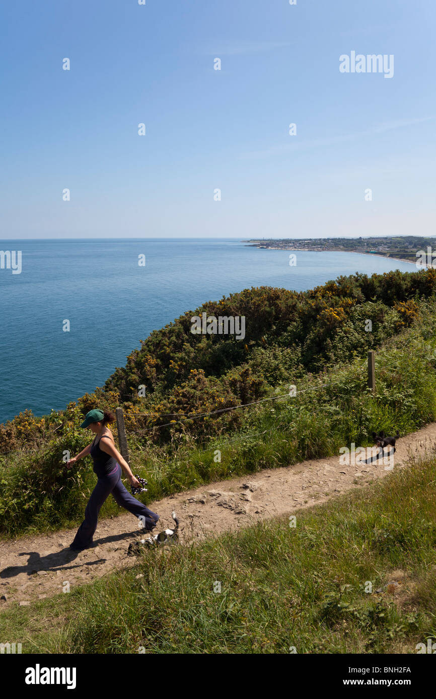 View of woman and dog on the Cliff Walk along Bray Head to Greystones Stock Photo