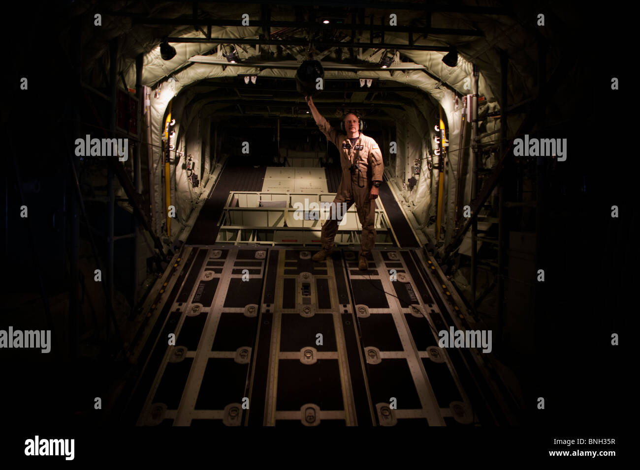 Loadmaster and raised ramp on a Lockheed Martin-built C-130J Super Hercules airlifter. Stock Photo