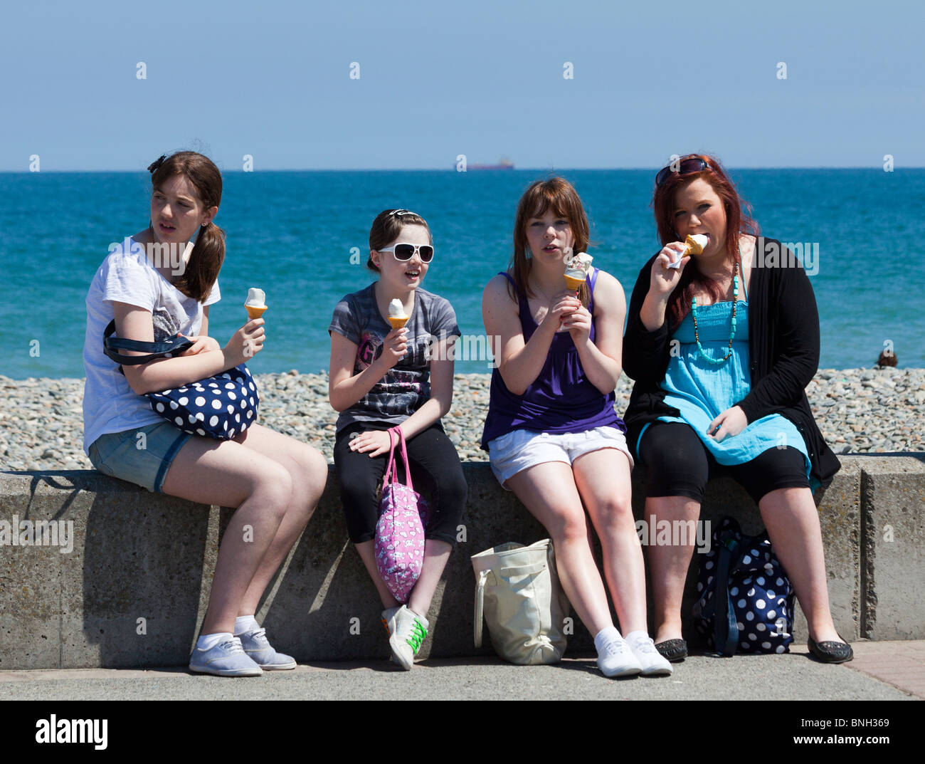 girls eating ice cream, Bray seaside resort, Ireland Stock Photo