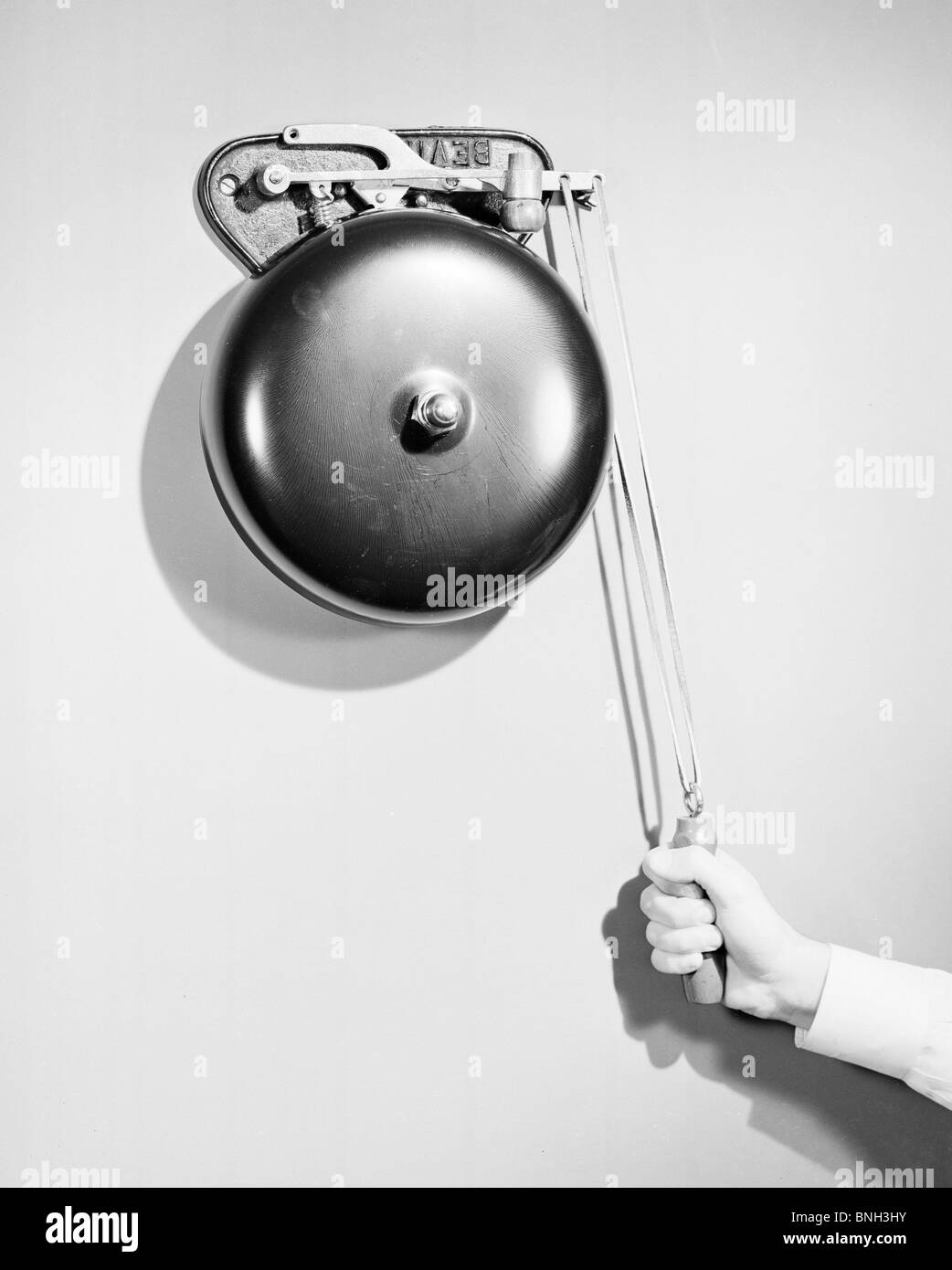Close-up of a person's hand ringing a bell Stock Photo
