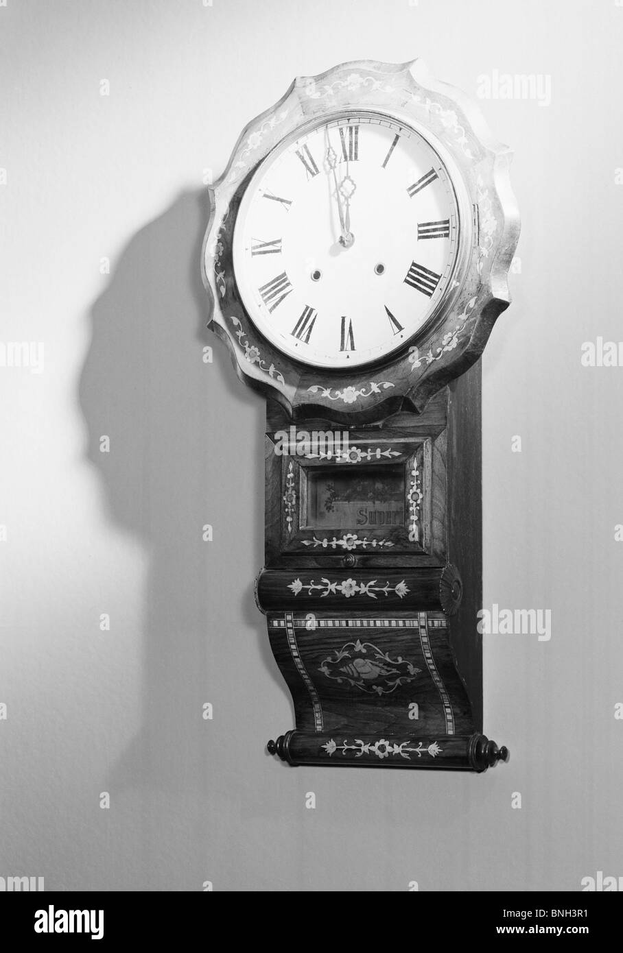 Close-up of a clock hanging on wall Stock Photo