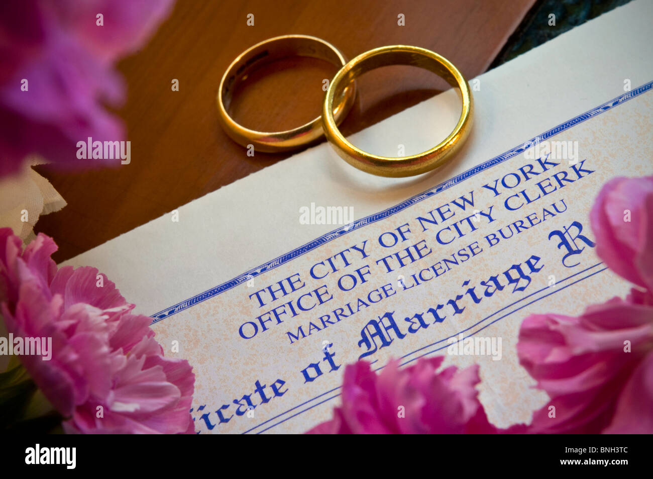 Marriage certificate on desk with two gold wedding rings City Hall Manhattan New York USA Stock Photo