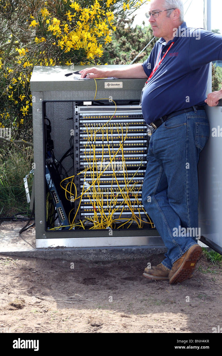 Engineer with Electrical Communications distribution box at St Andrews Old Course. Fife, Scotland, UK Stock Photo