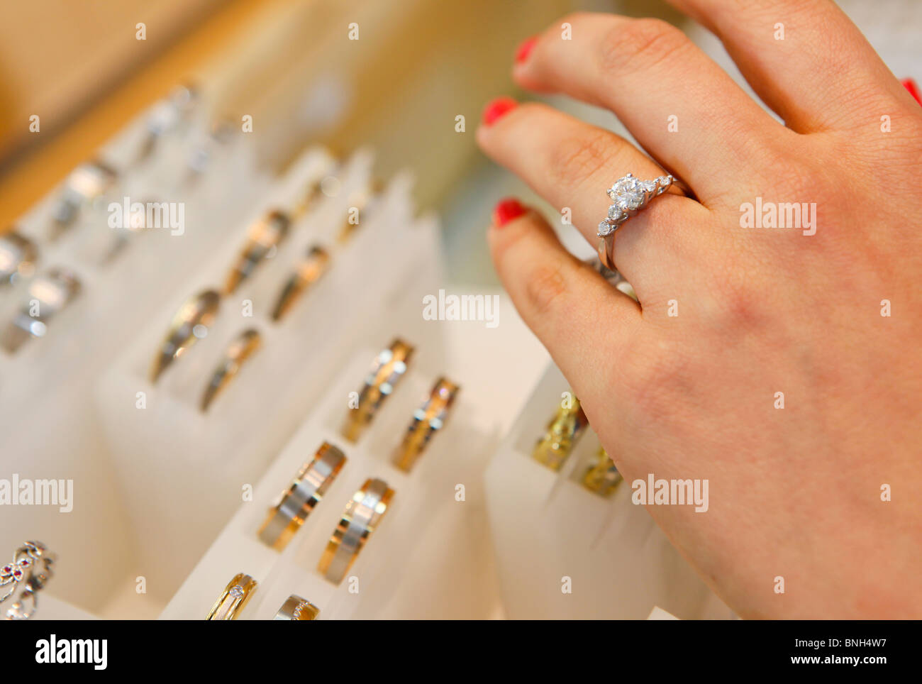 Woman trying on a ring at Jewellers at The Jewellery Quarter, Birmingham, West Midlands, England, UK Stock Photo