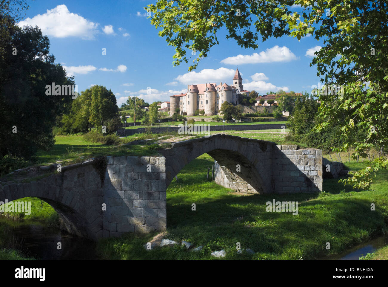 15th century bridge and the priory of Pommiers, in the Loire département of France Stock Photo
