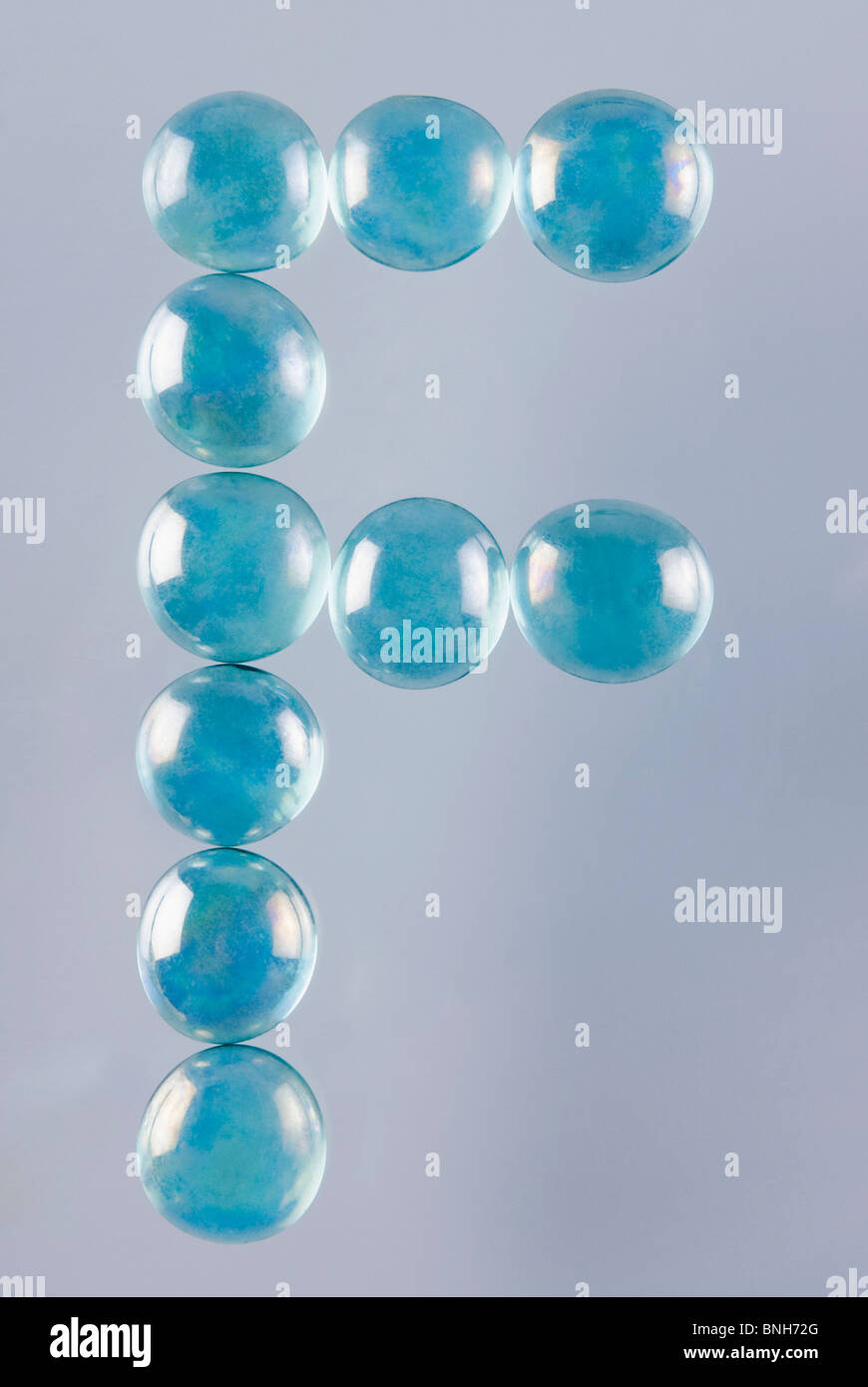 Close-up of marble balls arranged in the shape of letter F Stock Photo