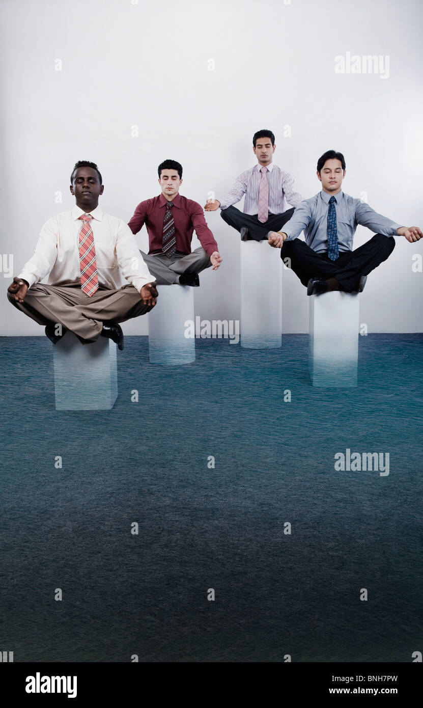 Four businessmen practicing yoga Stock Photo - Alamy
