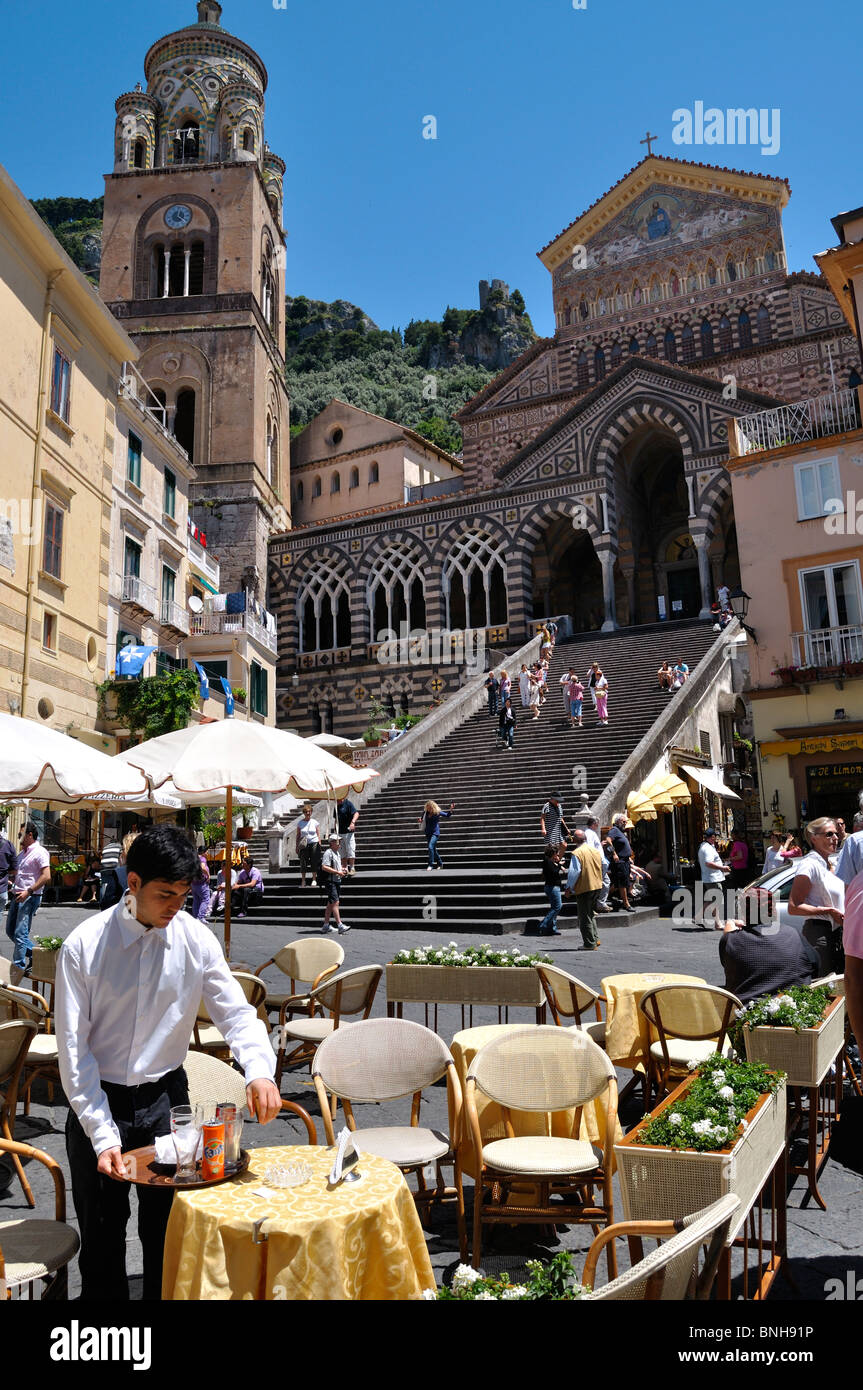 A waiter clears a table in Duomo Piazza, Amalfi Stock Photo