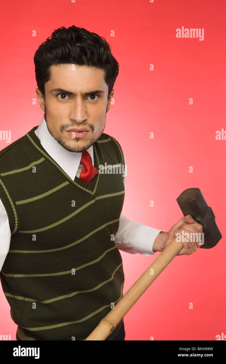 Portrait of a businessman holding a sledgehammer Stock Photo Alamy