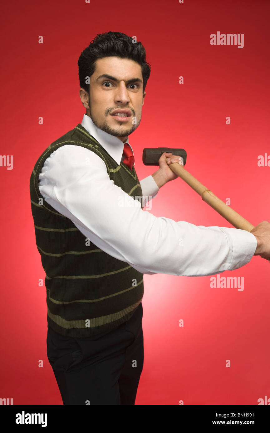 Portrait of a businessman holding a sledgehammer Stock Photo Alamy