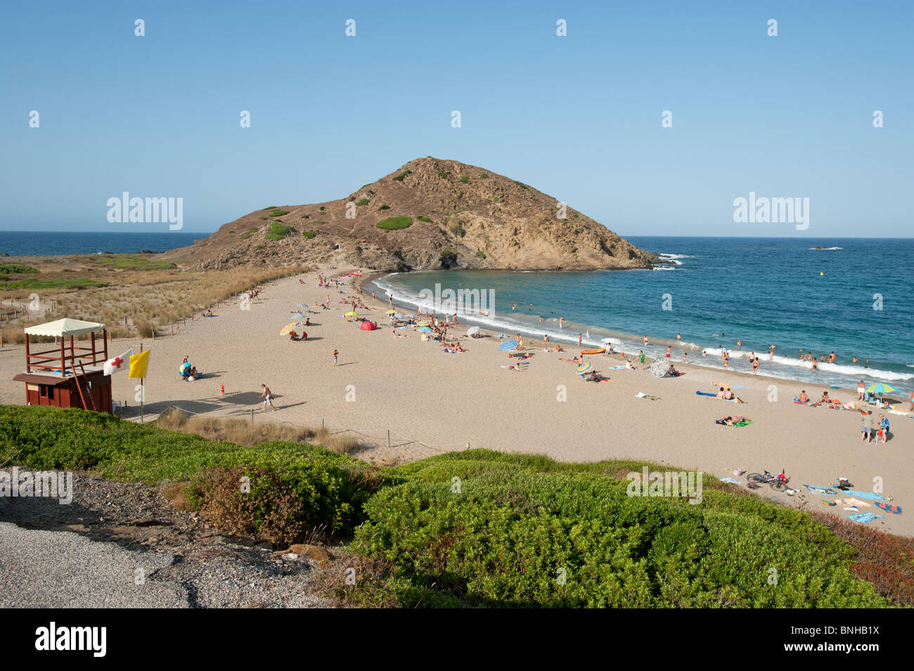 Tourists bathe on the beach at Cala Mesquida Menorca Spain Stock Photo