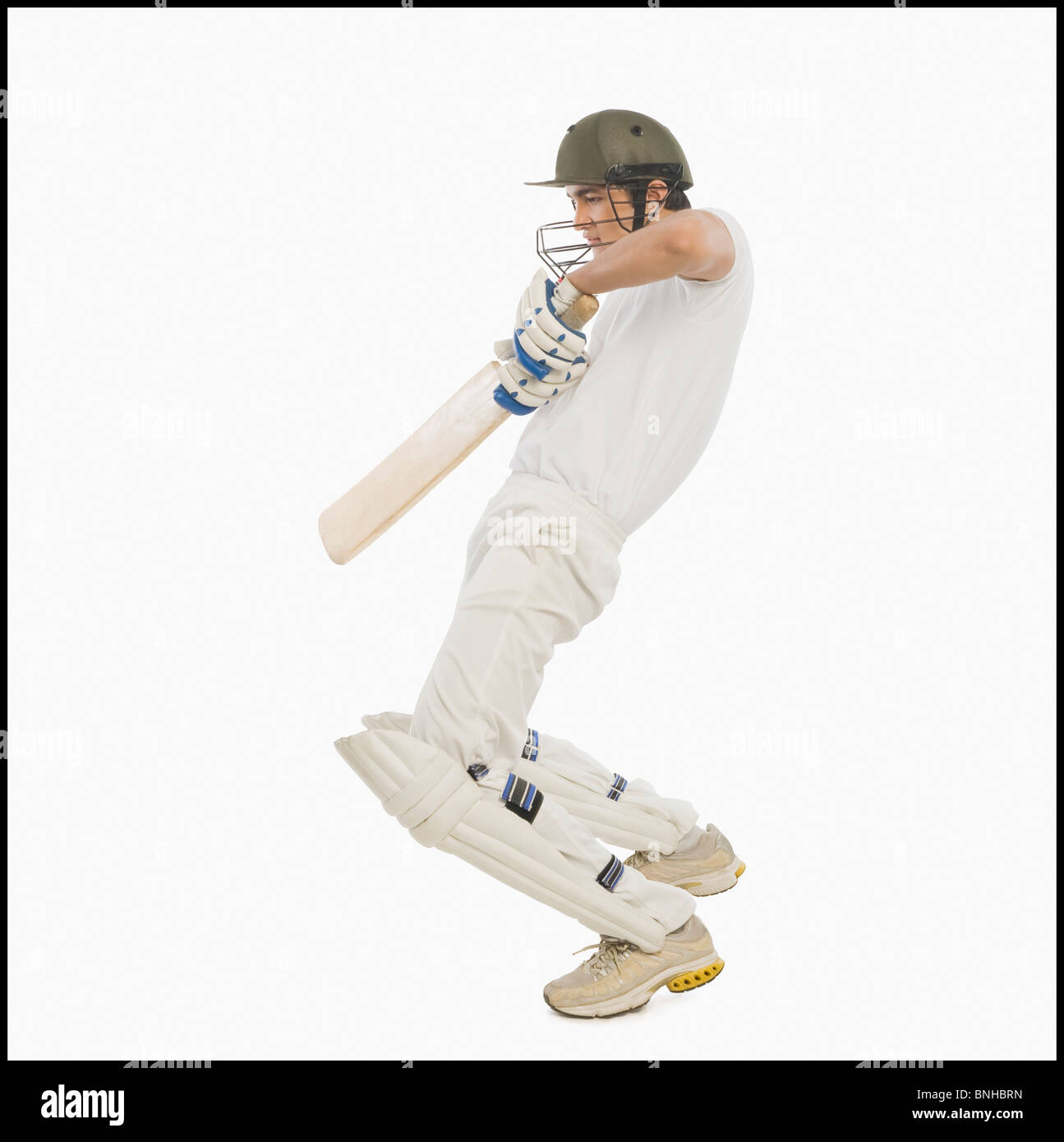 Cricket batsman playing a square cut shot Stock Photo